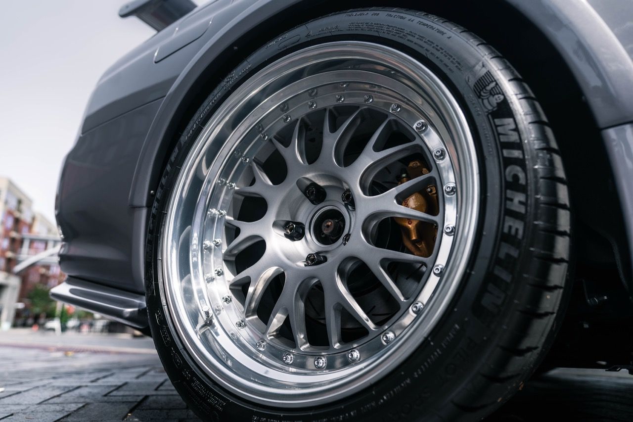R34 GTR with Motivo Forged CS-E custom wheels in frozen brushed gunmetal face and gloss polished clear lip side view — view 14