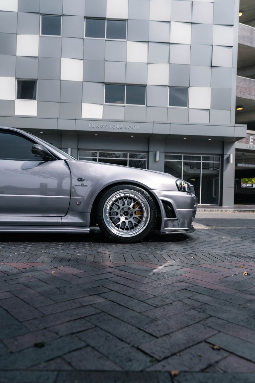 R34 GTR with Motivo Forged CS-E custom wheels in frozen brushed gunmetal face and gloss polished clear lip side view — view 18