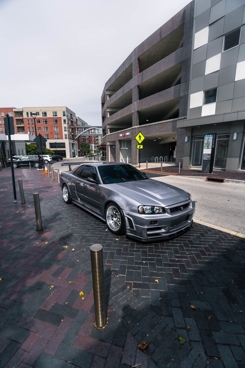 R34 GTR with Motivo Forged CS-E custom wheels in frozen brushed gunmetal face and gloss polished clear lip side view — view 40